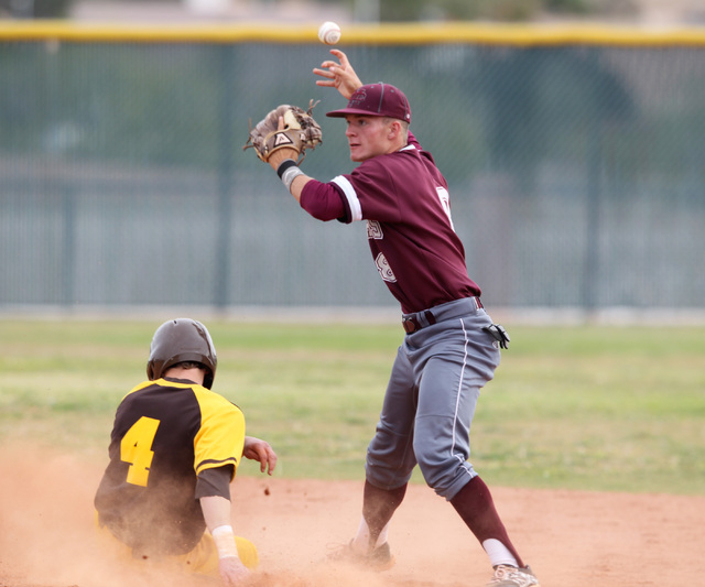 Cimarron Memorial’s Trent Bixby loses his grip on the ball while trying to turn a doub ...