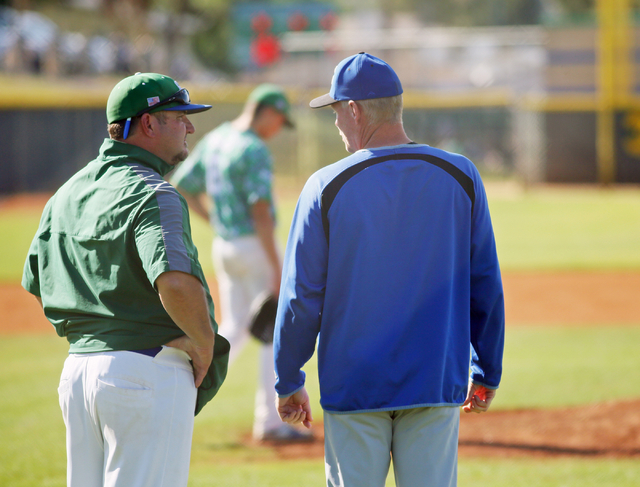 Green Valley head coach Corey Gehlken, left, and Basic head coach Scott Baker speak during a ...