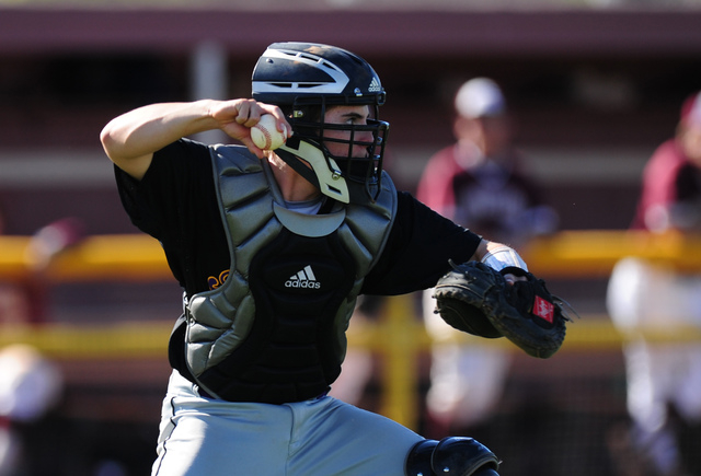 Durango catcher Josh Barry throws out Cimarron-Memorial base runner Luis Flores at second ba ...