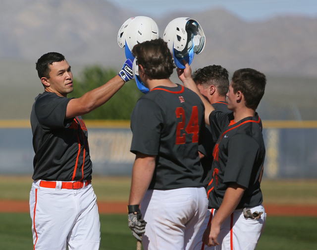 Bishop Gorman senior Brandon Wulff, left, celebrates with teammates Austin Cram (24), Beau C ...