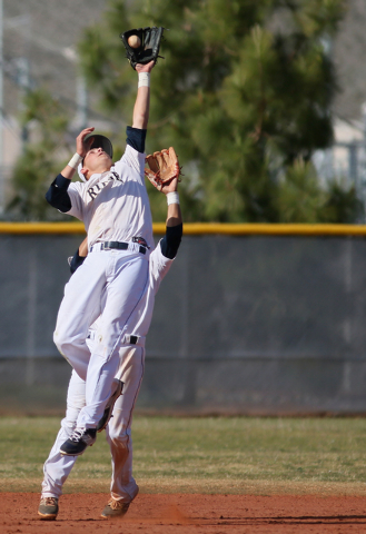 Shadow Ridge’s Quinn Ayers, front, jumps up for a catch near teammate Eric Jordan duri ...