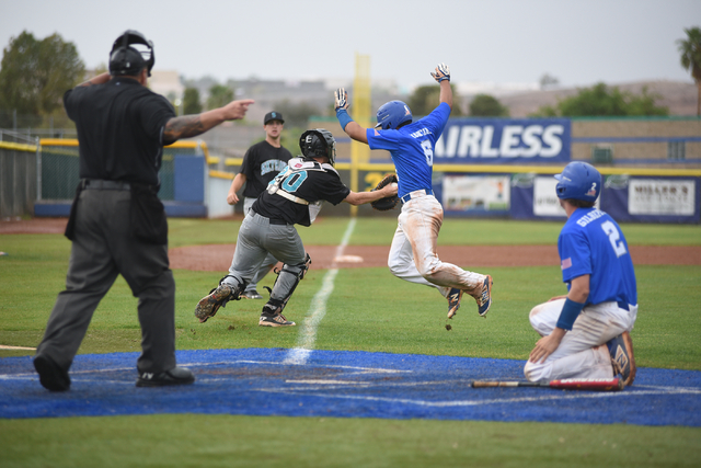 Silverado’s Michael Camburn (20) tags Green Valley’s Jimmy Montiel (6) out reach ...