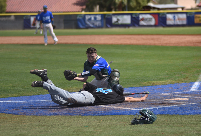 Silverado’s Michael Janosik (42) slides home for a run as Green Valley’s James L ...