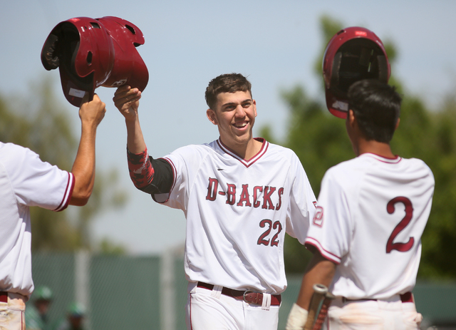 Desert Oasis senior Nolan Kingham, center, celebrates with teammates Dominic Paratore, left, ...