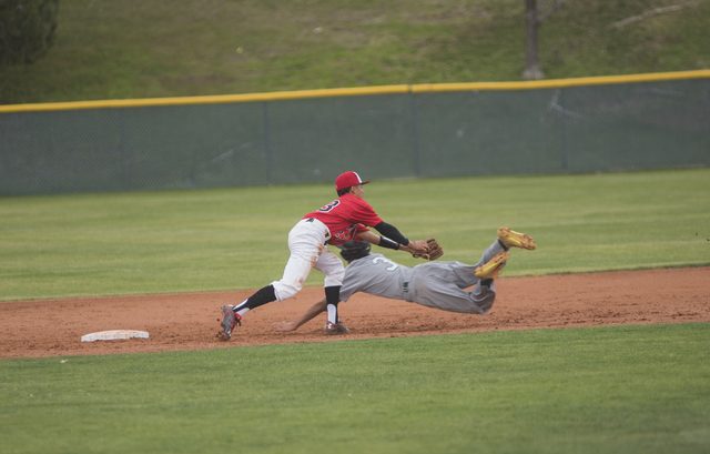 Rancho High School’s David Arambula (3) slides into second base as Las Vegas High Scho ...