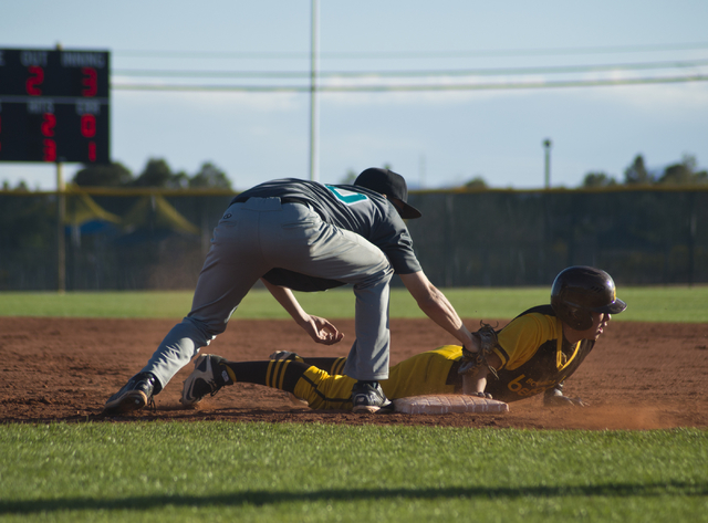 Bonanza’s Micah Higa (8) dives to tag first base as Silverado’s Samuel Pope (50) ...