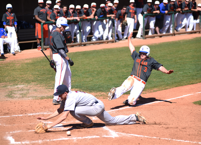 Bishop Gorman’s Mike Ruiz (3) slides into home for a score as Liberty’s Trevor M ...