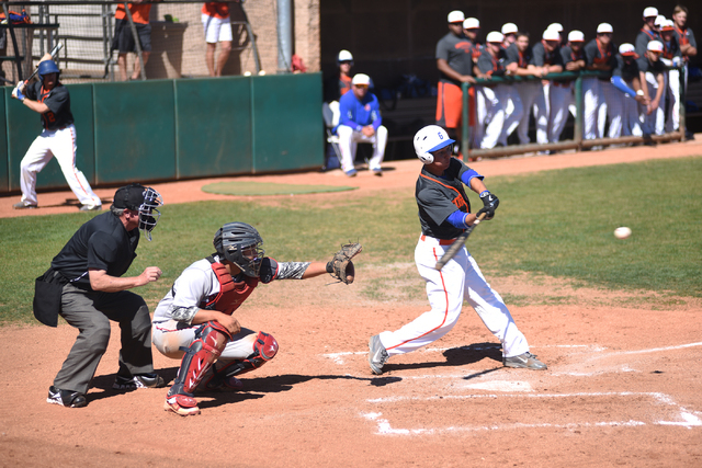 Bishop Gorman’s Antonio Rainone (1) swings at a pitch as Liberty’s Brandon Sorat ...