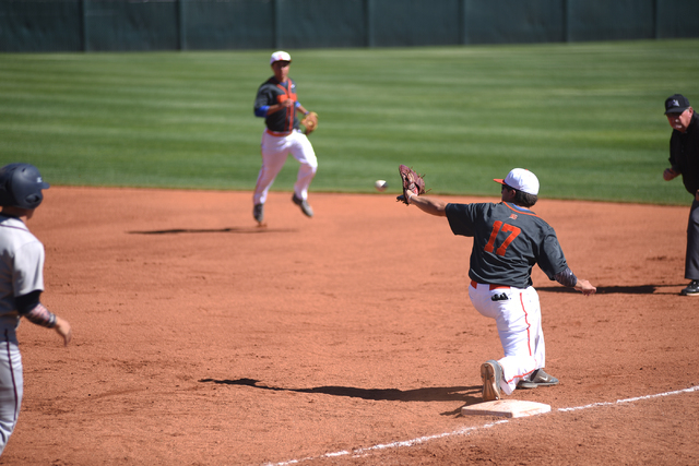 Bishop Gorman’s Tyler McKee (17) catches the ball for an out at first base against Lib ...