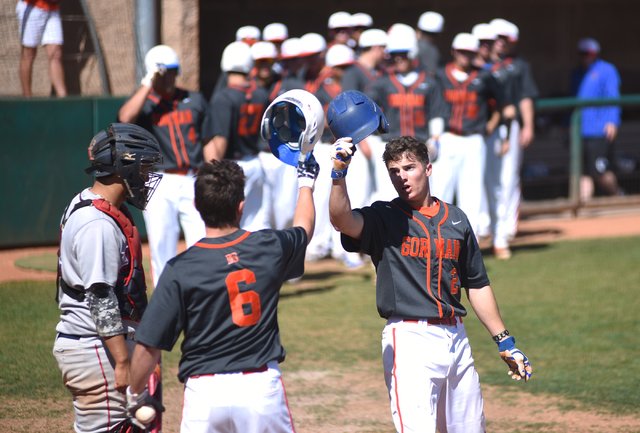 Bishop Gorman’s Cadyn Grenier (2) is congratulated by teammate Noah Serrano (6) after ...