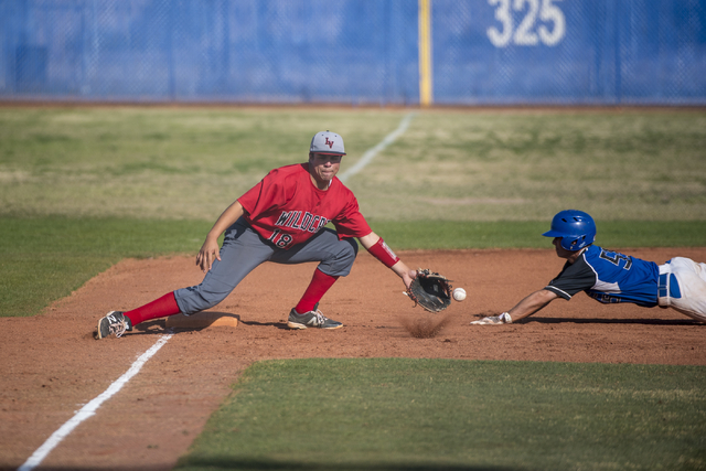 Las Vegas High School’s David Campbell (18) makes an error on the ball as Basic’ ...