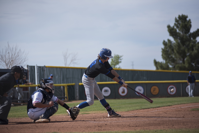 Basic’s Ryne Nelson (29) hits the ball in front of Coronado catcher Corben Bellamy dur ...