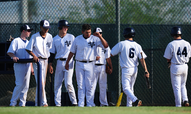 Spring Valley base runner William Reichel (6) high fives teammates after scoring the game&#8 ...