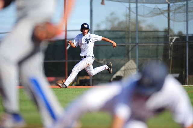 Spring Valley base runner Michael White watches a play at third base (foreground) while roun ...