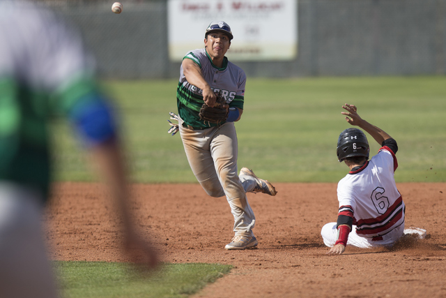 Green Valley’s Jimmy Montiel (6) throws the ball to first base for a double play again ...