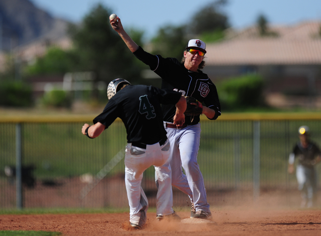 Palo Verde base runner Asher Bouldin (4) interferes with Desert Oasis shortstop Bryson Stott ...