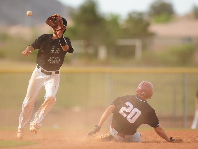 Desert Oasis base runner Ty Spiegel (20) steals second base as Palo Verde shortstop Ryan Mer ...