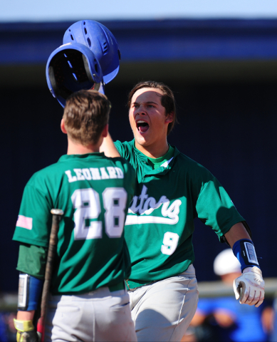 Green Valley batter Drake Maningo high fives James Leonard (28) after he hit a two-run home ...