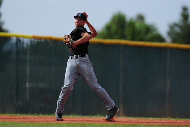 Silverado shortstop Dax Fellows throws out a Liberty base runner at first base in the third ...