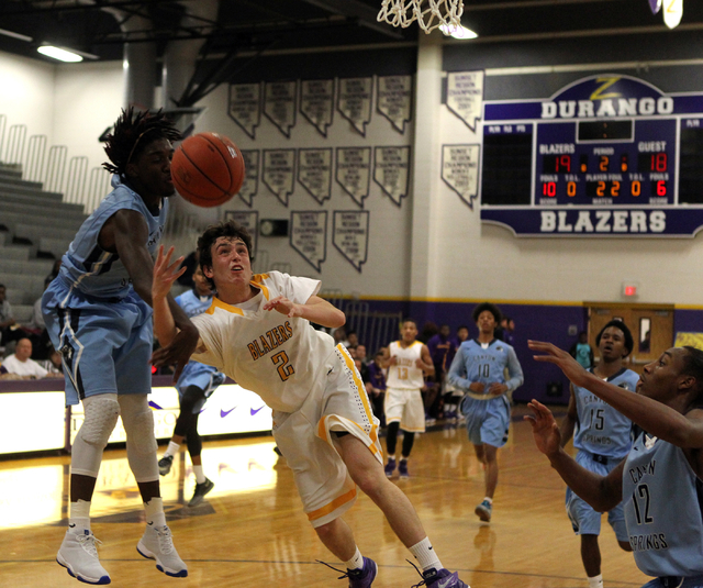 Durango guard Alex Tarkanian center shoots between Canyon Springs forward Kajuan Casey (5) a ...