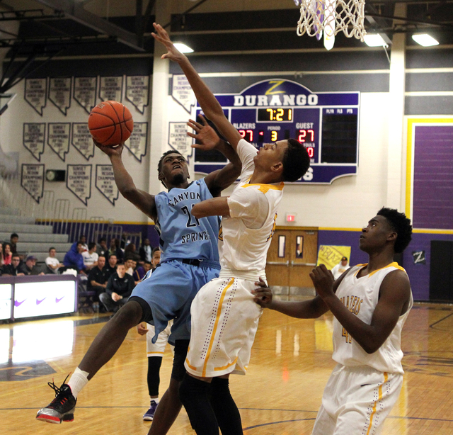 Canyon Springs guard D’Quan Crockett (21) shoots over Durango forward Michael Diggins ...