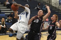 Centennial guard Tanjanae Wells (1) attempts a shot over Coronado guard Gabi Turturro (33) i ...