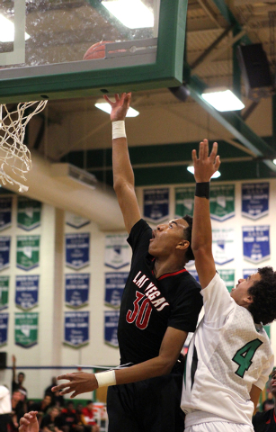 Las Vegas forward Tyler Bey (30) shoots in front of Green Valley shooting guard Xavier Jarvi ...