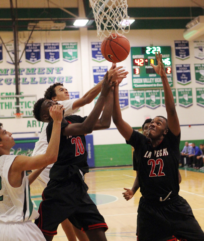 Las Vegas guards Patrick Savoy (22) and Dartanion Myers (20) battle for a rebound with Green ...