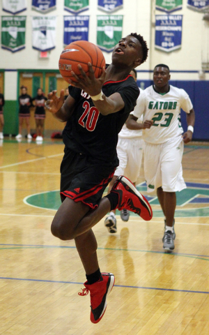 Las Vegas guard Dartanion Myers (20) shoots in front of Green Valley forward Romello Jones ( ...