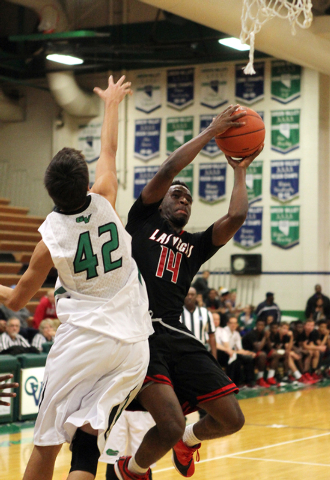 Las Vegas guard Deshawn Weathers (14) shoot past Green Valley forward Dylan Trejo (42) in th ...