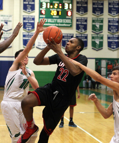 Las Vegas shooting guard Patrick Savoy (22) looks to shoot between Green Valley’s Bran ...