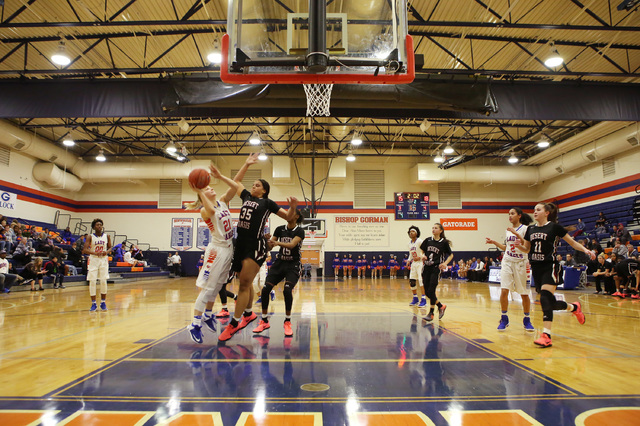 Bishop Gorman senior Samantha Coleman attempts a shot as Desert Oasis junior Dajaah Lightfoo ...