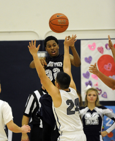 Agassi Prep guard Kenneth Hatano (32) passes the ball while jumping in front of The Meadows ...