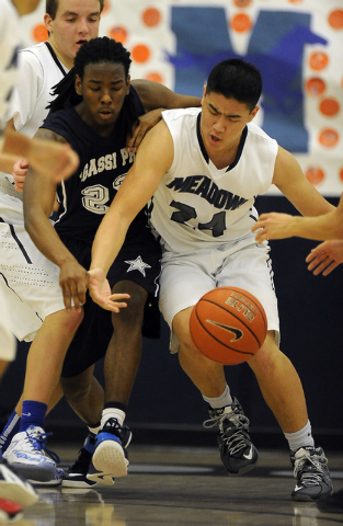 The Meadows School forward Michael Jin, right, and Agassi Prep guard Jordan Smith battle for ...