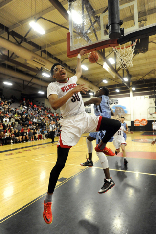 Canyon Springs guard D’Quan Crockett, background, blocks a layup attempt from Las Vega ...