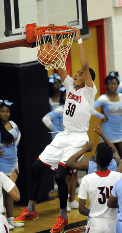 Las Vegas High forward Tyler Bey (30) dunks against Canyon Springs during the first quarter ...