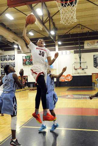 Las Vegas High forward Tyler Bey (30) dunks against Canyon Springs during the third quarter ...