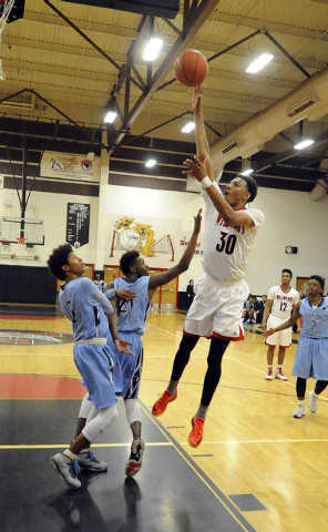 Las Vegas forward Tyler Bey makes a field goal in front of Canyon Springs gaurd Zaahid Muham ...