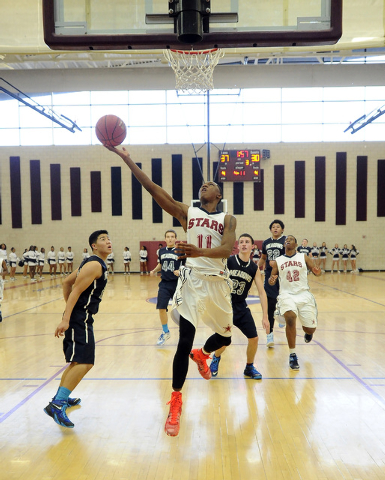 Agassi Prep guard Deishuan Booker (11) goes up for a layup against The Meadows on Saturday. ...