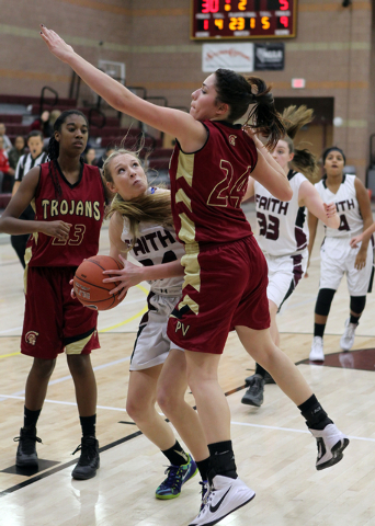 Faith Lutheran’s Morgan Hill (24) looks to shoot past Pahrump’s Helen Vann (24) ...