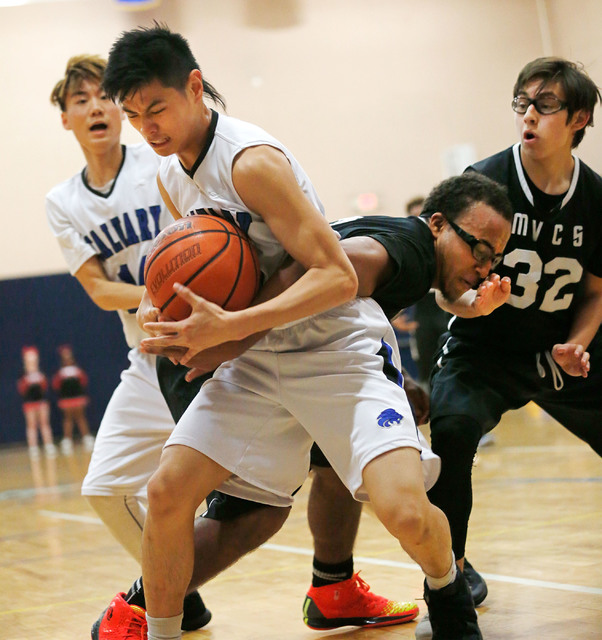 Calvary Chapel’s Marior Munda, left, keeps a ball away from Mountain View’s Isia ...