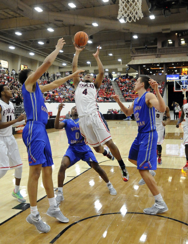 Findlay Prep guard Allonzo Trier (4) drives in for a layup as Bishop Gorman guard Ugo Amadi ...