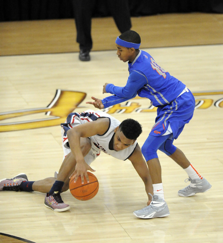 Findlay Prep guard Allonzo Trier (4) is tripped up by Bishop Gorman guard Julian Payton (10) ...