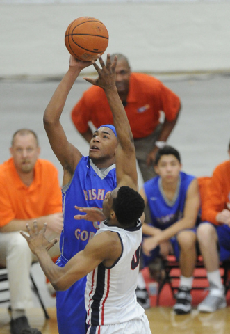 Bishop Gorman guard Charles O’Bannon Jr. (5) shoots as Findlay Prep forward Horace Spe ...