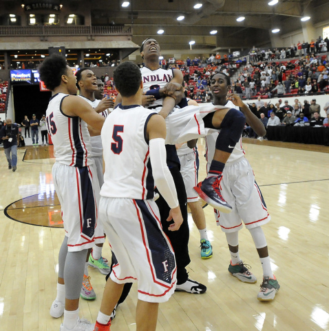 Findlay Prep players hoist Horace Spencer III (0) after Spencer’s blocked shot preserv ...