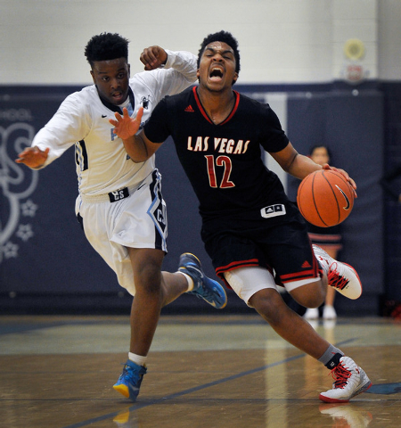 Las Vegas’ Devon Colley (12) brings the ball down court against Canyon Springs’ ...