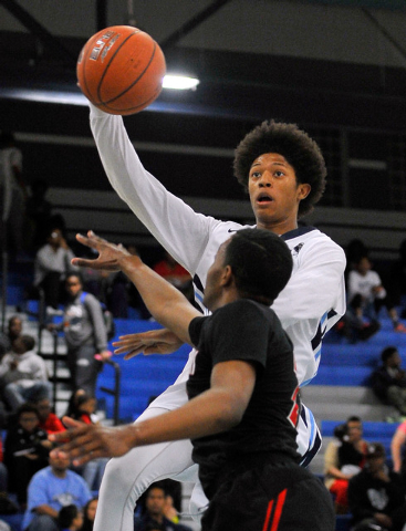 Canyon Springs’ Zaahid Muhammad shoots against Las Vegas’ Patrick Savoy on Monda ...