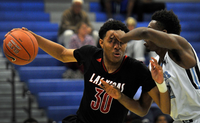 Las Vegas’ Tyler Bey (30) is defended by Canyon Springs’ D’Quan Crockett o ...