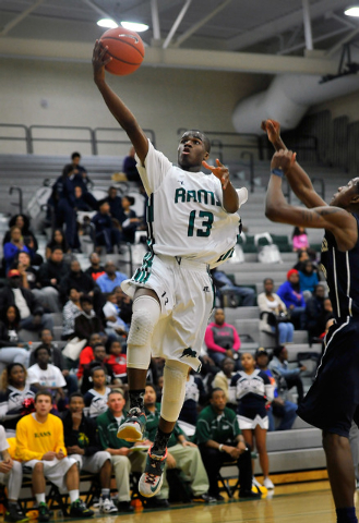 Rancho High’s Kenneth Smith drives past Agassi Prep’s Deishuan Booker on Monday. ...