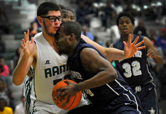 Agassi prep’s Dennis Walker, right, drives into Rancho’s Michael Hernandez on Mo ...